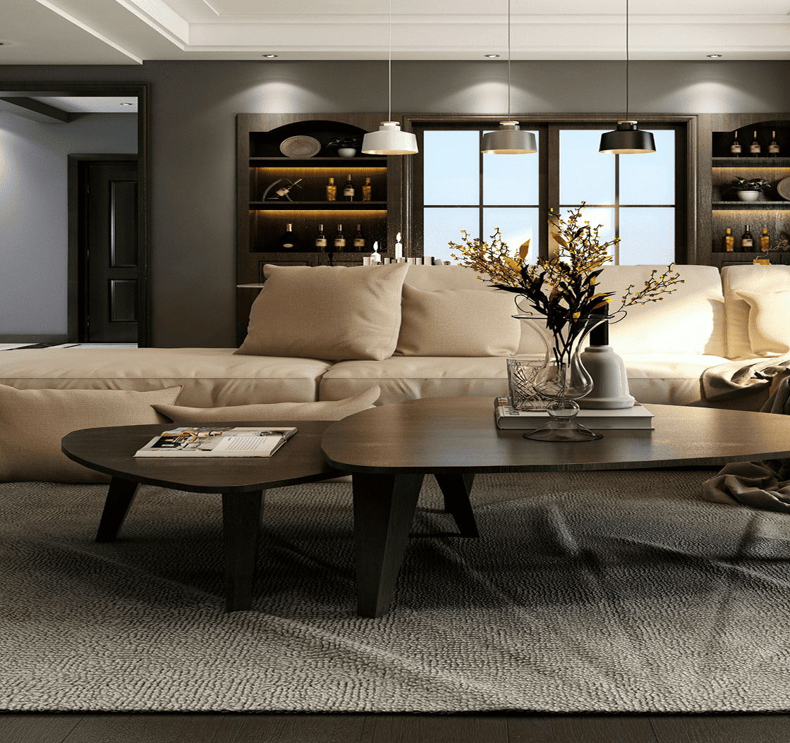 A modern living room with a beige sofa, two dark wood coffee tables, and a vase of dried flowers.
