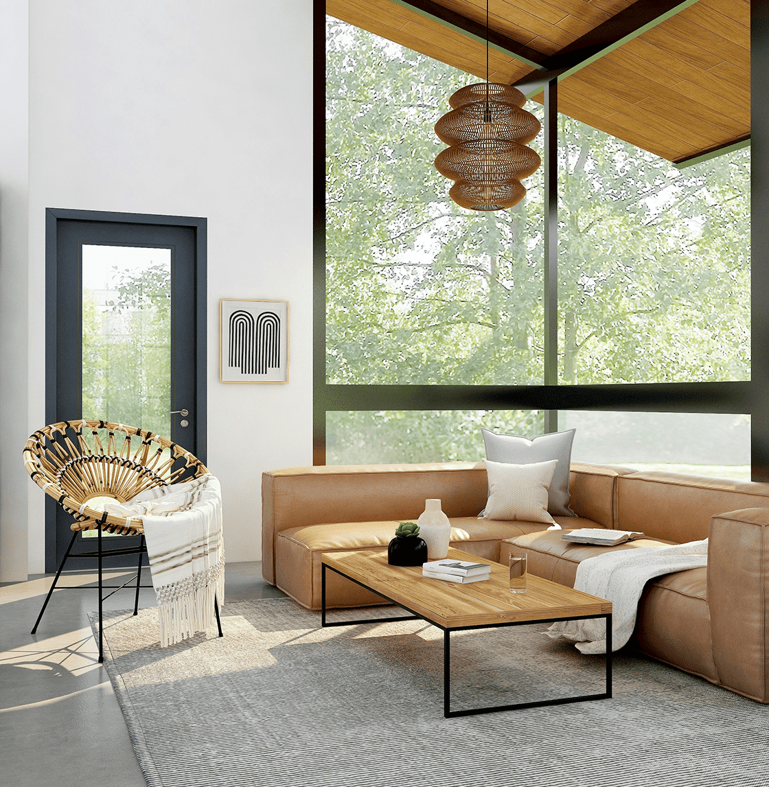 A modern living room with a brown leather sectional, a wicker chair, and a large window overlooking trees.