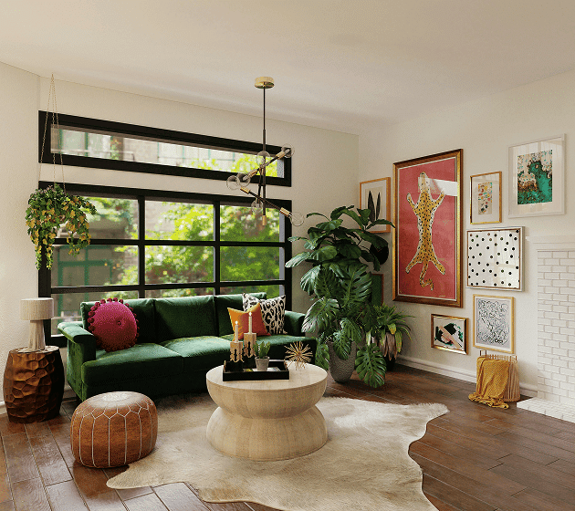 A vibrant living room with a green velvet sofa, a light wood coffee table, and a gallery wall.